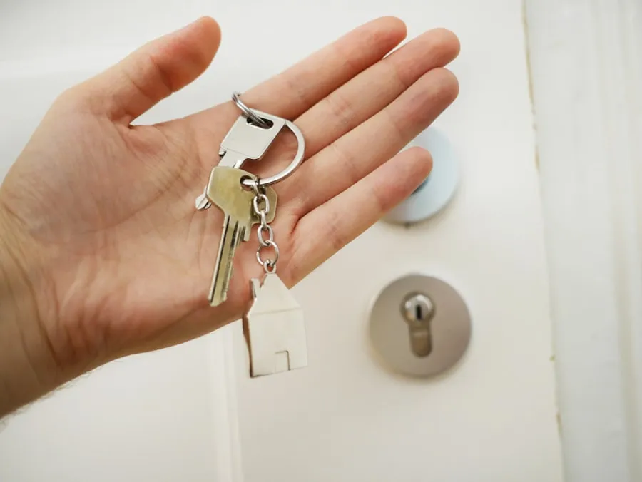 A locksmith holding a set of freshly cut keys.
