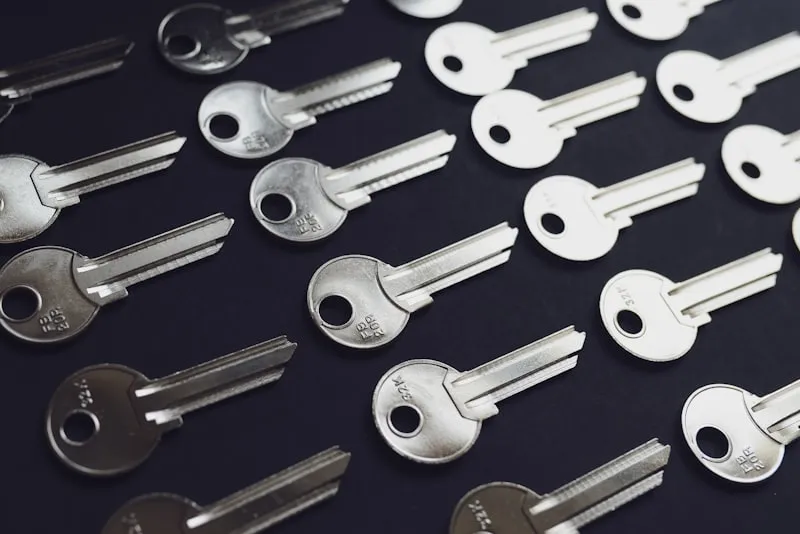 A set of old keys laid out on a workbench.
